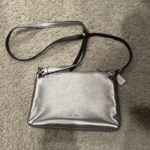 Coach silver cross body bag. 2 compartments and adjustable strap.